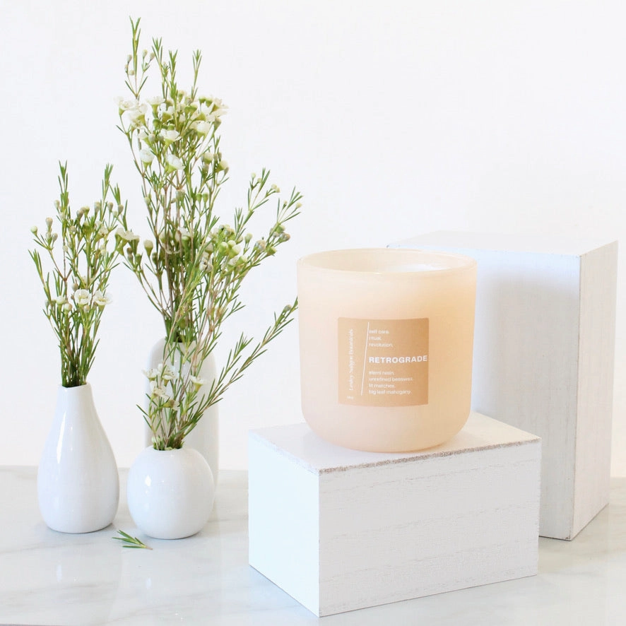 RETROGRADE Hand Poured Candle. Wood Wick. Elemi Resin. Lit Matches. Unrefined Beeswax. Big Leaf Mahogany. 14 oz. Blush Peach Matte. Large.